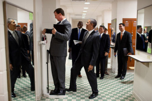 President Barack Obama puts his toe on the scale as Trip Director Marvin Nicholson tries to weigh himself during a hold in the volleyball locker room at the University of Texas in Austin, Texas, Aug. 9, 2010.  (Official White House Photo by Pete Souza) 